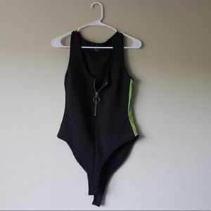 Black zip-up bodysuit with mesh neon green on the sides.